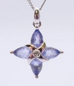 A 9 ct white gold, diamond and lilac stone pendant, on a 9 KT white gold chain. Pendant 1.