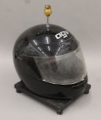 A motorcycle helmet-form table lamp. 38 cm high.