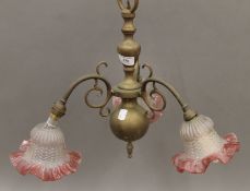 A brass and pink glass hanging light fitting. 42 cm high.