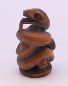 A wooden carving of a snake. 6 cm high.
