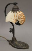 A nautilus shell-mounted table lamp. 31 cm high.
