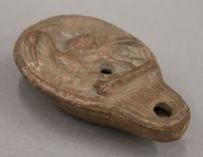 An antiquity pottery oil lamp. 9.5 cm long.