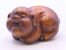 A wooden carving of a pig. 4 cm high.