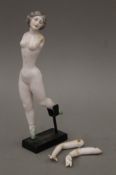 A late 19th/early 20th century porcelain model of a ballerina mounted on a display stand.