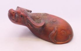 A wooden carving of a water buffalo. 7 cm long.