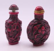 Two snuff bottles with stoppers. Each approximately 8.5 cm high.