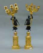 A pair of gilt bronze figural candelabra. Each 71 cm high.