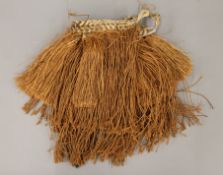 A vintage traditional two-tiered grass/palm fibre skirt, Asmat, Papua New Guinea, Indonesia.