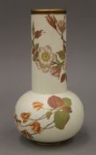 A Royal Worcester porcelain vase decorated with flowers. 23 cm high.