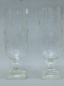 A pair of cut-glass hurricane lamps. Each 34 cm high.