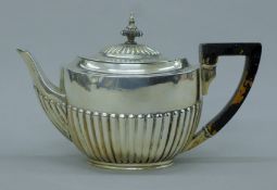 A silver teapot. 24 cm long. 484.9 grammes total weight.
