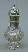 A large embossed silver sugar castor. 19 cm high. 237.7 grammes.