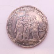 An 1873 silver French 5 francs coin.