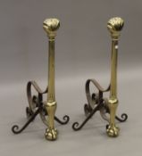 A pair of 19th century brass and iron fire dogs. 68 cm high.