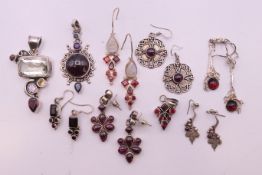 A quantity of garnet-set jewellery to include earrings and pendants. Largest pendant 5.