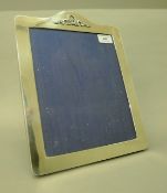 A Mappin & Webb silver photograph frame. 32.5 cm high.