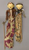 Two vintage Javanese (Indonesia) Wayang Golek carved wood painted rod puppets with batik fabric