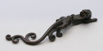 A bronze dog-of-fo scroll weight. 16 cm long.