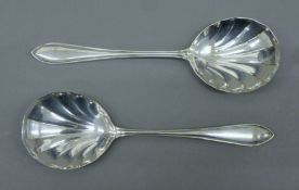 A pair of silver serving spoons. Each 20.5 cm long. 130 grammes.