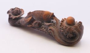 A wooden ruyi sceptre with fish. 10 cm long.