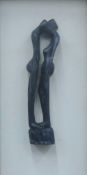 An abstract wooden carving of a couple embracing, housed in a glazed box frame. 30.