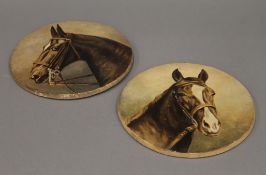 A pair of pottery plaques painted with a horse head portraits. Each 21.5 cm diameter.