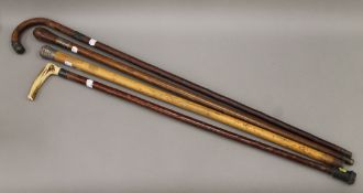 Four silver-mounted walking sticks. The largest 92.5 cm long.