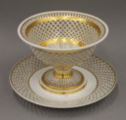 A gilt decorated Vienna porcelain reticulated centre bowl on stand. 18.5 cm high.