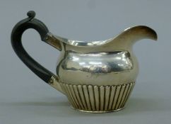 A Russian silver cream jug. 13.5 cm long. 104.4 grammes total weight.