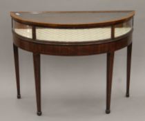 A 19th century line inlaid mahogany demi-lune vitrine. 114 cm wide.