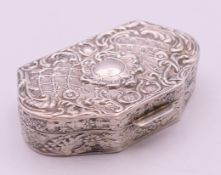 A silver snuff box with allover repousse decoration with gilt interior. 5.5 x 3.5 cm.
