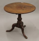 A George III mahogany tilt-top tripod table. 77 cm diameter.