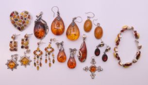 A quantity of amber jewellery to including earrings, a brooch, a bracelet and pendants.