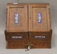 A Victorian enamel-set oak stationary box. 39 cm wide.