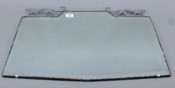 An Art Deco mirror surmounted with a pair of jaguars. 65 cm wide.