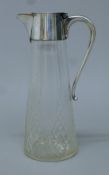 A silver plate-mounted cut glass claret jug. 26 cm high.