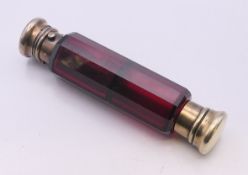A Victorian ruby glass double-ended scent and vinaigrette bottle with faceted sides. 14 cm long.