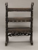 A 19th century Eastern carved hardwood bookcase. 95 cm wide x 145 cm high.