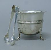 A silver sugar bowl and tongs. The bowl 6.5 cm high. 131.2 grammes.