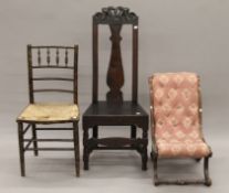 An 18th century oak side chair, a nursing chair and a side chair. The former 46 cm wide.