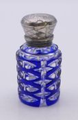 A Victorian glass scent bottle with silver-hinged top and original stopper decorated in blue