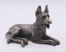 A silver model of a dog (possibly a German Shepherd/Alsatian) set with gold and ruby eyes,