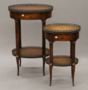 Two leather-topped two-tier side tables. The larger 56.5 cm wide x 87 cm high.