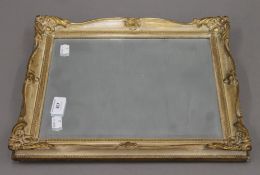 A small gilt-framed bevelled mirror. 31 x 38 cm.