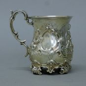 A Victorian embossed silver mug. 10 cm high. 190.6 grammes.