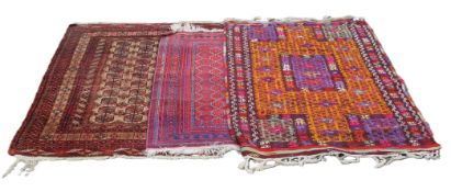 Three Eastern red ground rugs. 166 x 108 cm, 140 x 90 cm and 164 x 122 cm.
