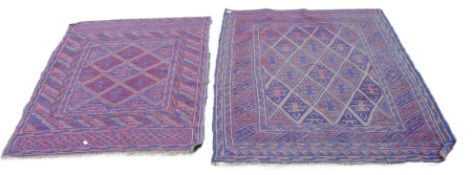 Two small red and blue ground rugs. The larger 120 x 140 cm.
