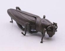 An articulated locust. 8 cm long.