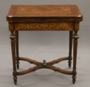 A 19th century-style fold-over games tables. 72 cm wide.