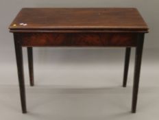 A 19th century mahogany folding tea table. 95 cm wide.